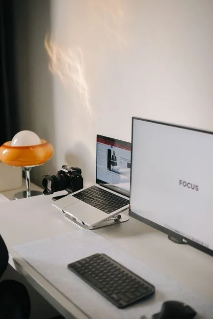 A smartphone placed in a tiny shopping cart on a laptop represents online shopping and digital payments.
